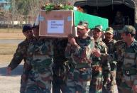 Indian army personnel carry the coffin of soldier Lance Naik Sudhakar Singh at Rajouri, some 148 kms from Jammu, on January 9, 2013. India delivered a dressing-down Wednesday to Islamabad's envoy to Delhi as it accused Pakistan's army of beheading one of two soldiers killed in Kashmir, but both sides warned against inflaming tensions