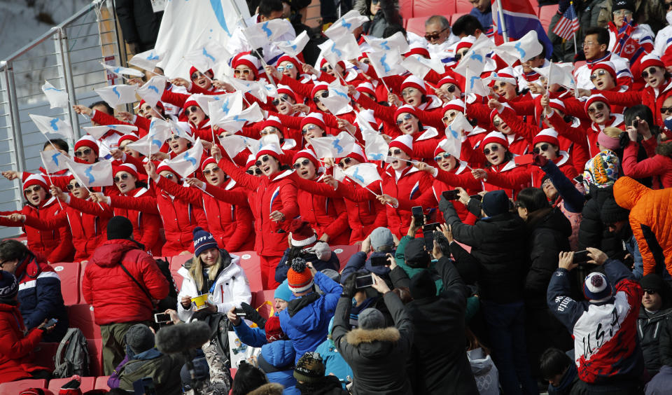 <p>People take photos of North Korean cheerleaders as they perform in the finish area during the first run of the men’s giant slalom at the 2018 Winter Olympics in Pyeongchang, South Korea, Sunday, Feb. 18, 2018. (AP Photo/Christophe Ena) </p>