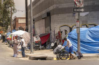 Tents line the streets of Skid Row area of Los Angeles Friday, July 22, 2022. In Los Angeles, which is down 650 officers from its pre-pandemic staffing, units that deal with homeless outreach and animal cruelty are shuttered and human trafficking, narcotics and gun details have been downsized. “Police should be nowhere around outreach. You can’t be the provider of services as well as the jailer,” said Pete White, the founder and executive director of the Los Angeles Community Action Network. “My hope ... is that those resources that go to the police department are actually pointed towards real solutions.” (AP Photo/Damian Dovarganes)