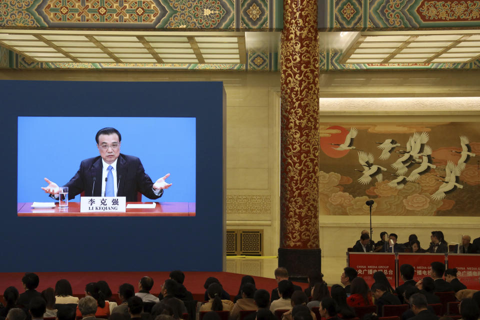 Chinese Premier Li Keqiang is displayed on a screen during a press conference after the closing session of the National People's Congress in Beijing's Great hall of the People on Friday, March 15, 2019. (AP Photo/Ng Han Guan)