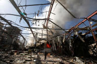 <p>Smoke rises at a community hall where Saudi-led warplanes struck a funeral in Sanaa, the capital of Yemen on Oct. 9, 2016. (Khaled Abdullah/Reuters)</p>