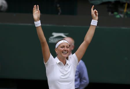 Petra Kvitova of the Czech Republic celebrates after defeating Eugenie Bouchard of Canada in their women's singles final tennis match at the Wimbledon Tennis Championships in London July 5, 2014. REUTERS/Suzanne Plunkett