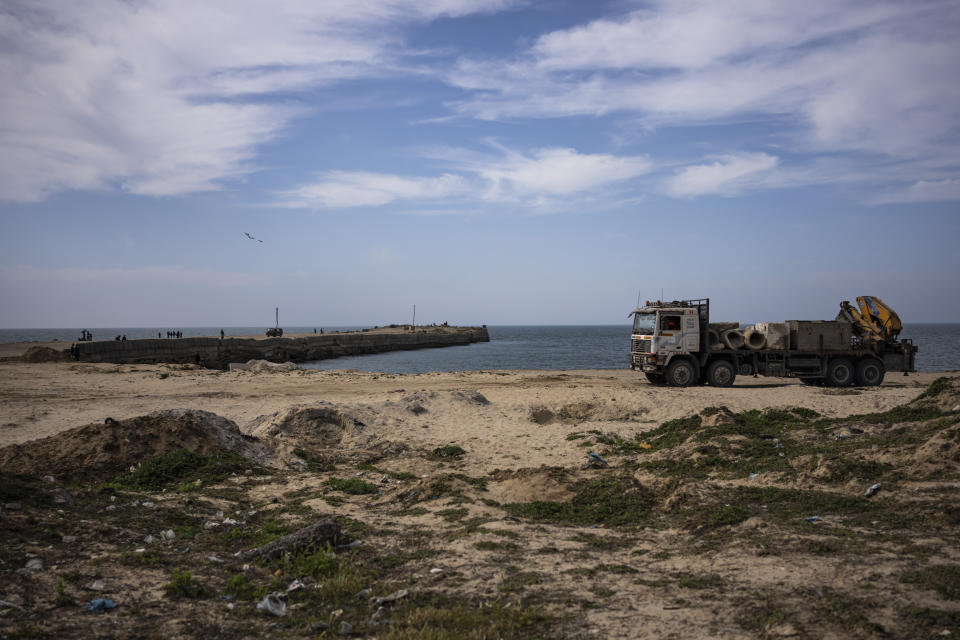 Palestinians bring cement blocks to a pier that could be used to bring humanitarian aid to the Gaza Strip in Khan Younis on Wednesday, March 13, 2024. (AP Photo/Fatima Shbair)