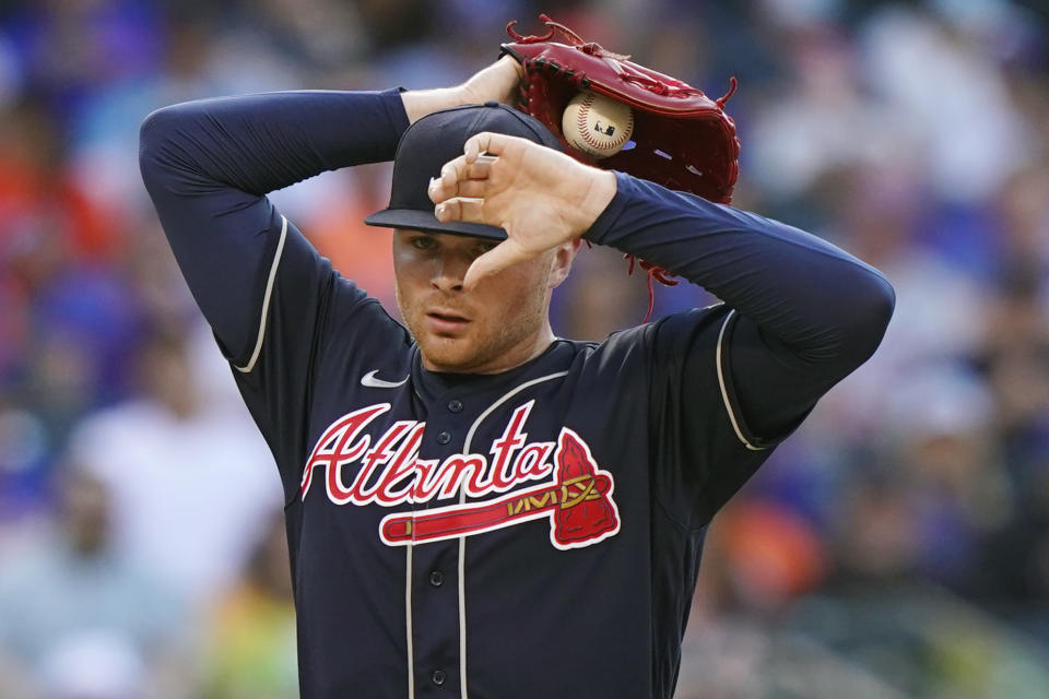 Atlanta Braves relief pitcher Sean Newcomb reacts after allowing a three-run double to New York Mets' Dominic Smith in the fifth inning of the first baseball game of a doubleheader, Monday, June 21, 2021, in New York. (AP Photo/Kathy Willens)