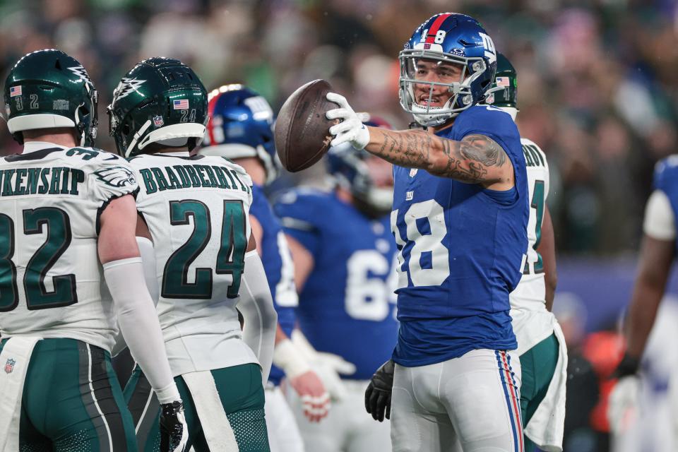 Jan 7, 2024; East Rutherford, New Jersey, USA; New York Giants wide receiver Isaiah Hodgins (18) reacts after first down during the first quarter against the Philadelphia Eagles at MetLife Stadium. Mandatory Credit: Vincent Carchietta-USA TODAY Sports