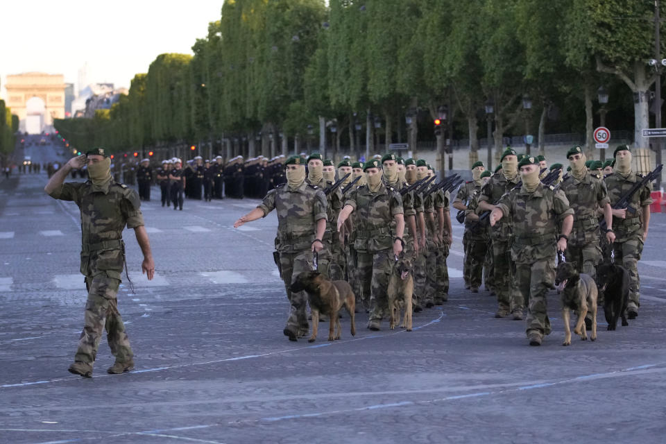 French soldiers march on the Champs Elysees avenue during a rehearsal for the Bastille Day parade in Paris, France, Monday, July 11, 2022. Paris is preparing for a big Bastille Day parade later this week, a military show on the Champs-Elysees avenue that this year will honor war-torn Ukraine and include troops from countries on NATO's eastern flank: Poland, Hungary, Slovakia, Romania, Bulgaria, Czechia, Lithuania, Estonia and Latvia. (AP Photo/Christophe Ena)