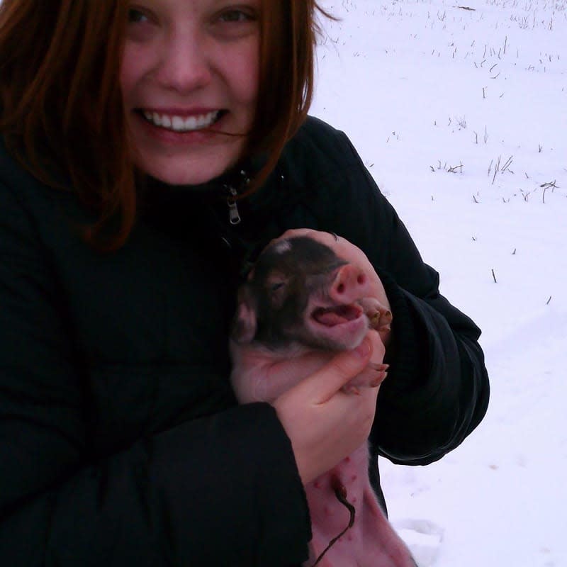 The author and a week-old piglet.