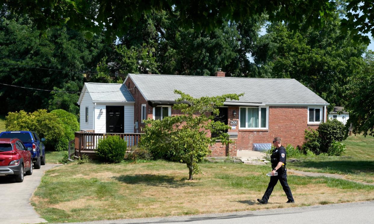 <span>A police officer walks past a home believed to be connected to the shooter in the Donald Trump assassination attempt in Bethel Park, Pennsylvania, on Monday.</span><span>Photograph: Gene J Puskar/AP</span>