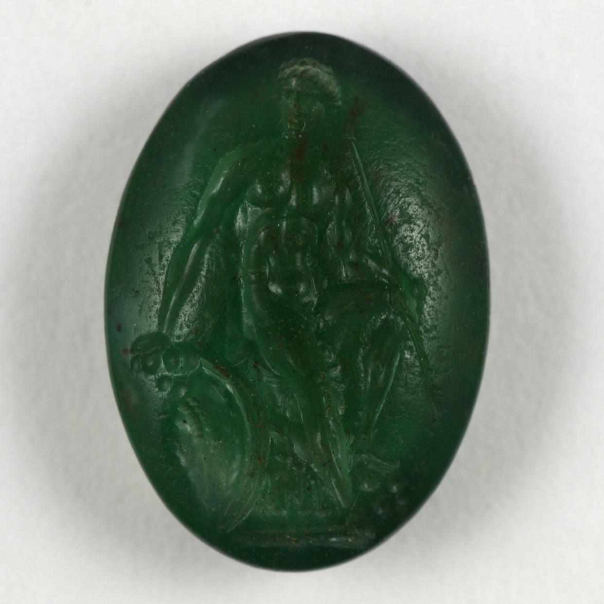 Hellenistic plasma intaglio, engraved with a young warrior seated on a rock, dated 323–31 BC, which is similar to the missing items (A Masson-Berghoff/PA)