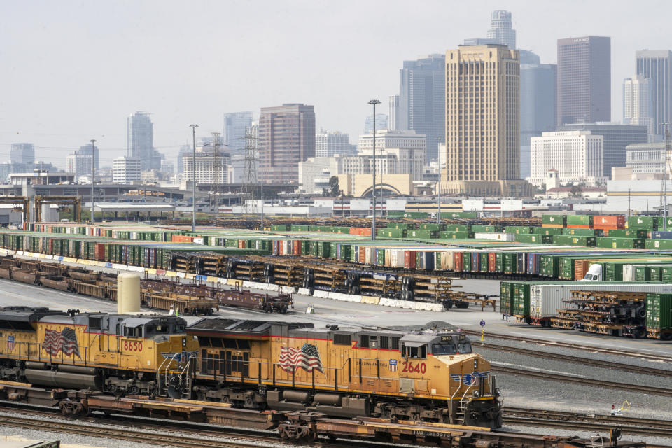 Los Angeles skyline is seen above the Union Pacific LATC Intermodal Terminal is seen on Tuesday, April 25, 2023 in Los Angeles. California's Air Resources Board is set to vote on a rule to cut greenhouse gas and smog-forming emissions from diesel-powered locomotives used to pull rail cars through ports and railyards.(AP Photo/Damian Dovarganes)