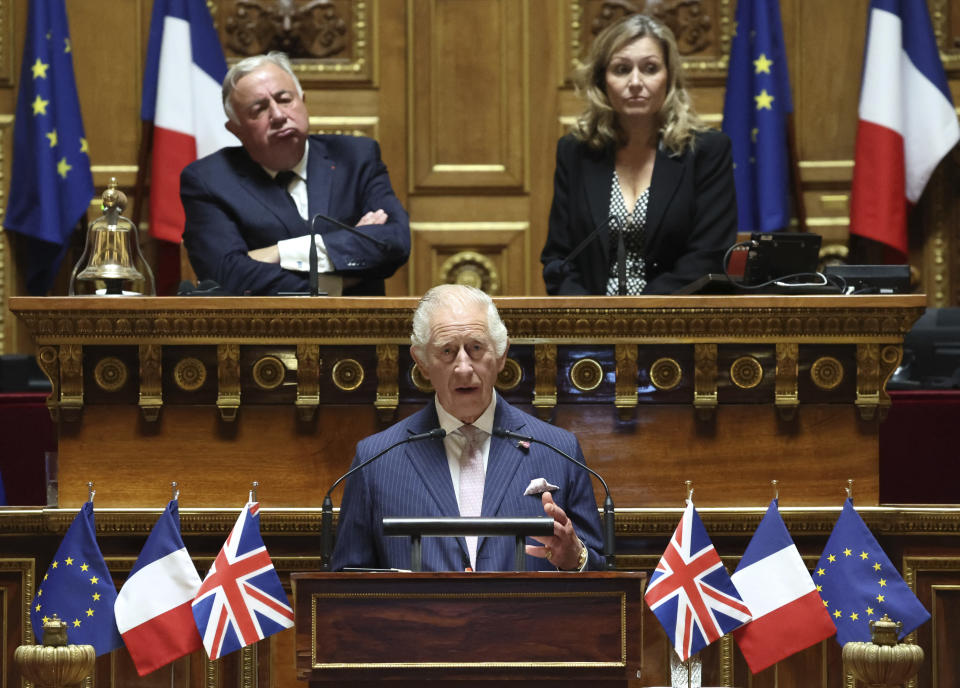 FILE - Britain's King Charles III addresses French lawmakers from both the upper and the lower house of parliament as Senate President Gerard Larcher, top left, and President of the French National Assembly Yael Braun-Pivet listen at the French Senate, Thursday, Sept. 21, 2023 in Paris. At an age when many of his contemporaries have long since retired, King Charles III is not one to put his feet up. The king will mark his 75th birthday on Tuesday, Nov. 14, 2023, by highlighting causes close to his heart. (Emmanuel Dunand, Pool via AP, File)