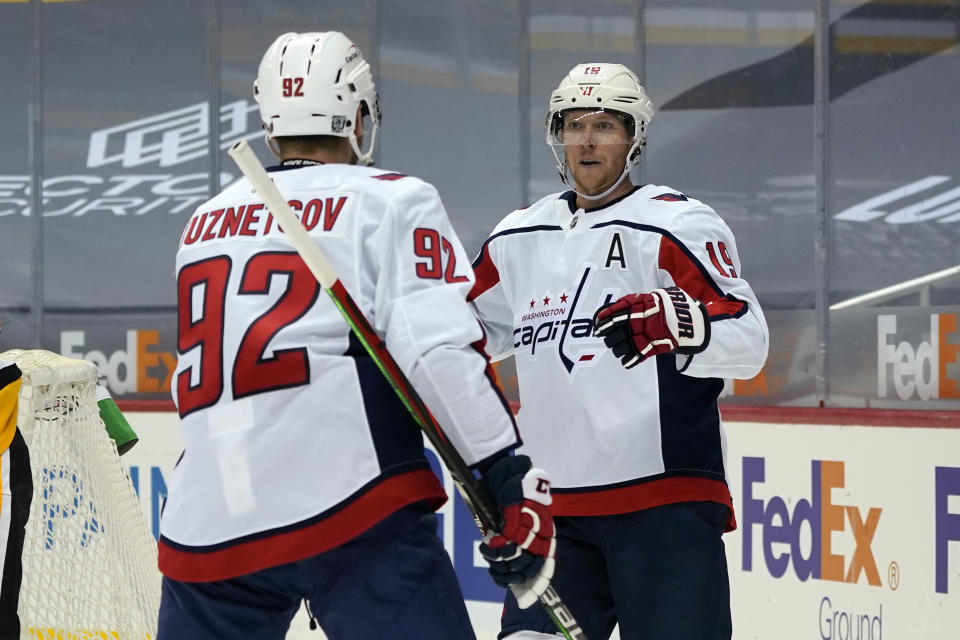 Washington Capitals' Nicklas Backstrom (19) celebrates his goal with Evgeny Kuznetsov during the second period of an NHL hockey game against the Pittsburgh Penguins in Pittsburgh, Sunday, Jan. 17, 2021. (AP Photo/Gene J. Puskar)