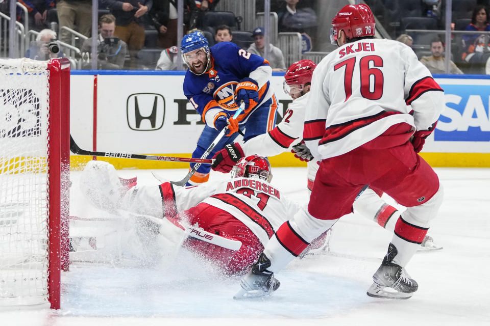 Carolina Hurricanes goaltender Frederik Andersen (31) and teammate Brady Skjei (76) protect their net from New York Islanders' Kyle Palmieri (21) during the second period of Game 6 of an NHL hockey Stanley Cup first-round playoff series Friday, April 28, 2023, in Elmont, N.Y. (AP Photo/Frank Franklin II)