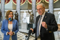 Senate Minority Leader Chuck Schumer of N.Y., with House Speaker Nancy Pelosi of Calif., speaks to reporters following a meeting at the Capitol with White House chief of staff Mark Meadows and Treasury Secretary Steven Mnuchin on a COVID-19 relief bill, Saturday, Aug. 1, 2020, in Washington. (AP Photo/Manuel Balce Ceneta)