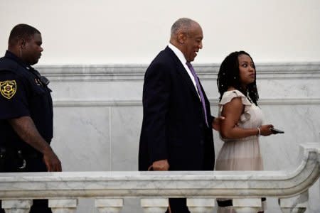 FILE PHOTO: Bill Cosby walks with publicist Ebonee Benson during a break in his sexual assault retrial case at the Montgomery County Courthouse in Norristown, Pennsylvania, U.S., April 18, 2018.   Corey Perrine/Pool via Reuters