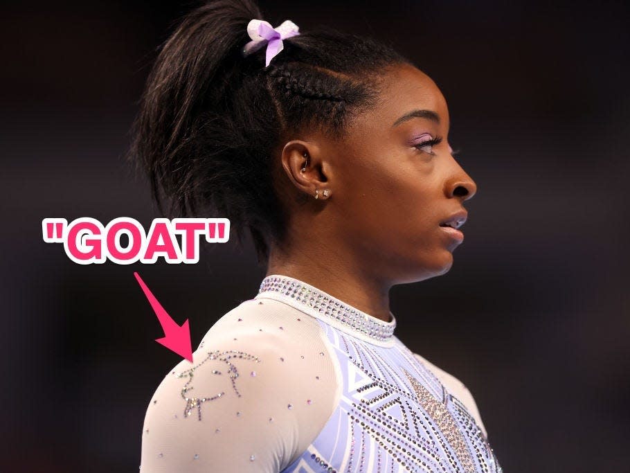 Simone Biles wearing a leotard with a goat on the shoulder.