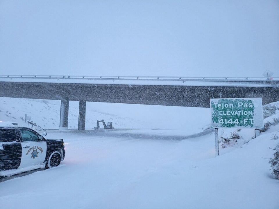 A California Highway Patrol vehicle navigates snow and ice that closed the Grapevine section of Interstate 5 over Tejon Pass Saturday morning, Feb. 25, 2023.