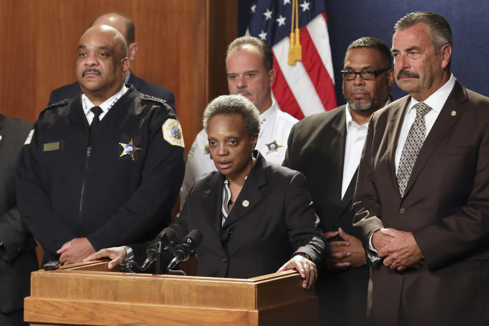 Chicago Mayor Lori Lightfoot, center, has named former Los Angeles police Chief Charlie Beck, right, to be Chicago's interim police superintendent on Friday, Nov. 8, 2019 in Chicago. The announcement comes a day after Superintendent Eddie Johnson, left, announced his retirement after more than three years as the city's police chief and more than 30 years with the department. (AP Photo/Teresa Crawford)