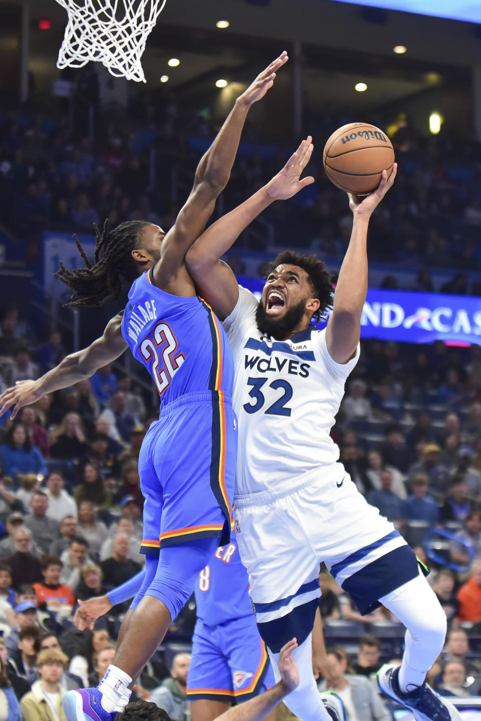 Minnesota Timberwolves center Karl-Anthony Towns (32) shoots against Oklahoma City Thunder guard Cason Wallac during the first half of an NBA basketball game Tuesday, Dec. 26, 2023, in Oklahoma City. (AP Photo/Kyle Phillips)