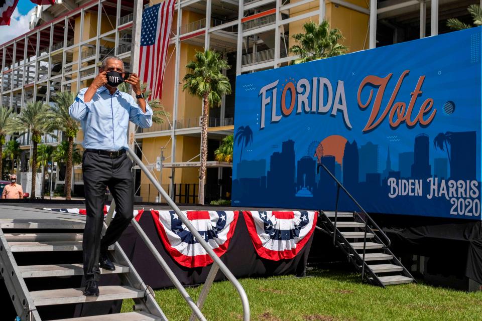 Former President Barack Obama leaves the stage after speaking at a drive-in rally for his former vice president, Democratic nominee Joe Biden, in Orlando, Florida on October 27, 2020.