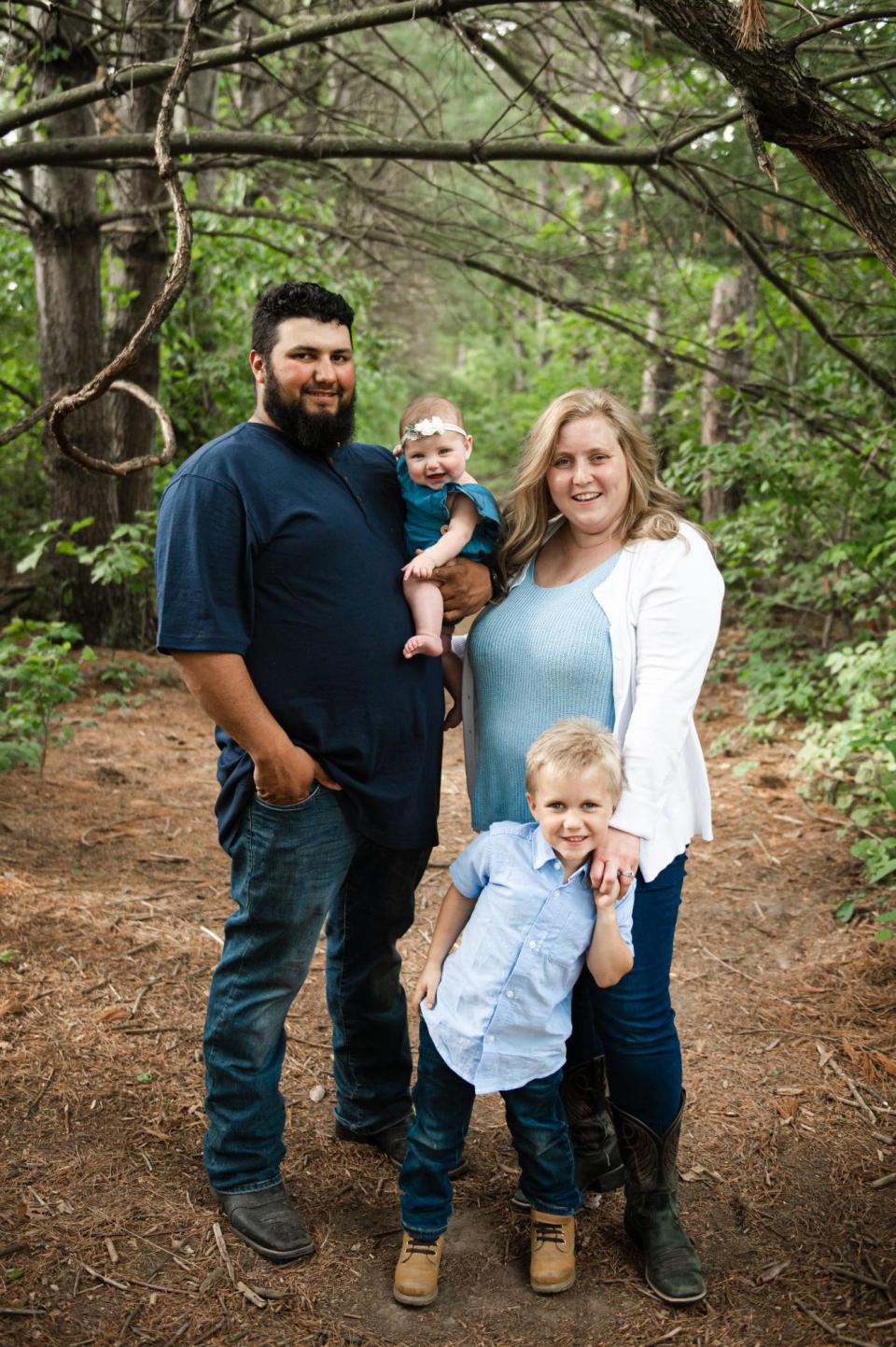 Lacey Pfeiffer, right, the new manager of Potawatomi Wildlife Park in Bourbon, stands with her family along one of the trails. At left is her husband, Kevin, holding their daughter, Lux. Their son is Kruz.