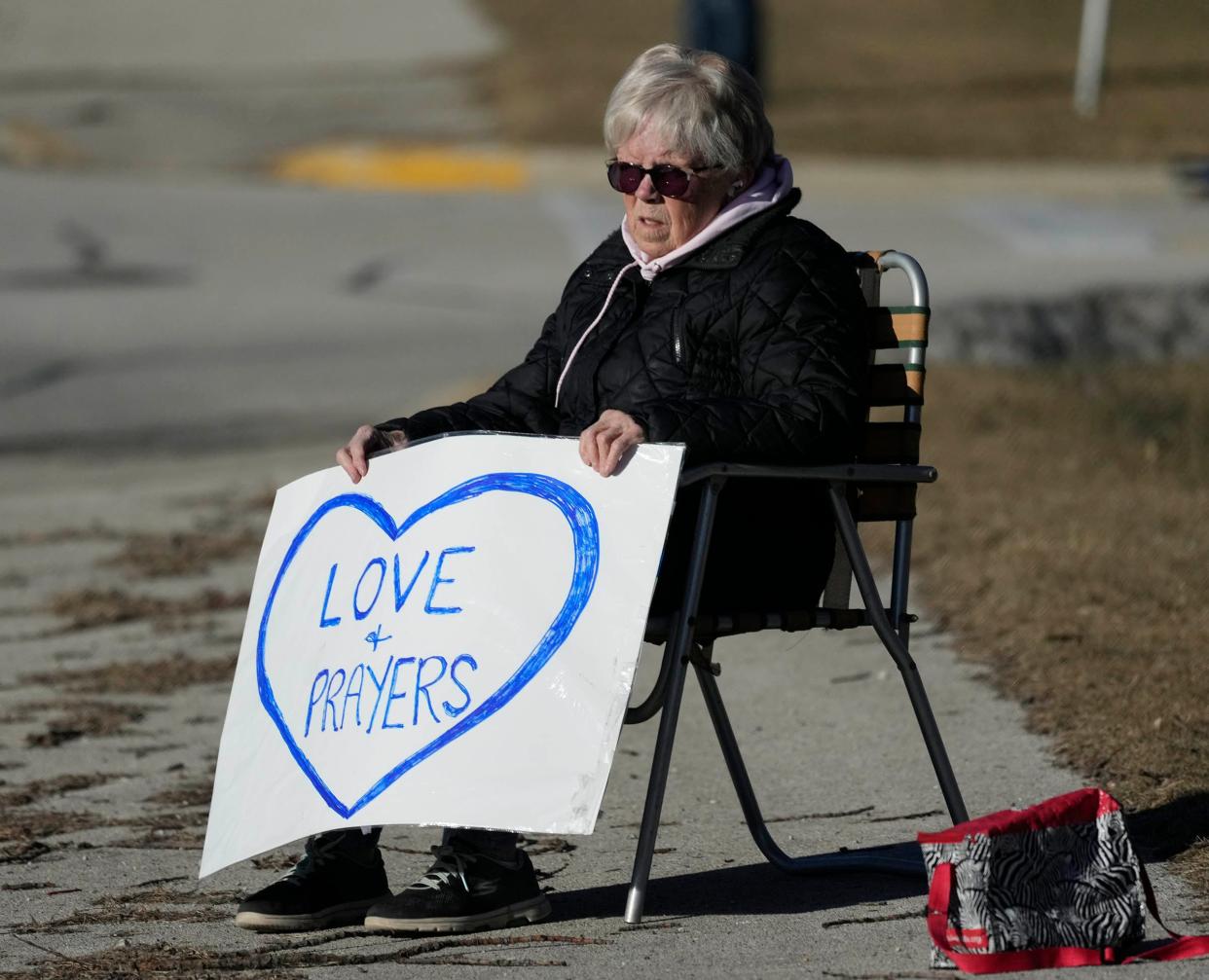 “We’ve come to too many of these”, said Bonnie Bruhn, of West Allis, referring to the third Milwaukee police officer funeral she's been to as she holds a sign outside Elmbrook Church during the funeral for Milwaukee police officer Peter Jerving in Brookfield on Monday, Feb. 13, 2023.
