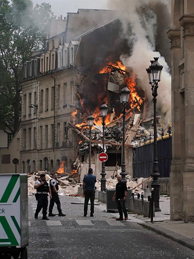 Smoke billows from the rubble of the building at Place Alphonse-Laveran in the 5th arrondissement of Paris on 21 June 2023 (AFP via Getty Images)