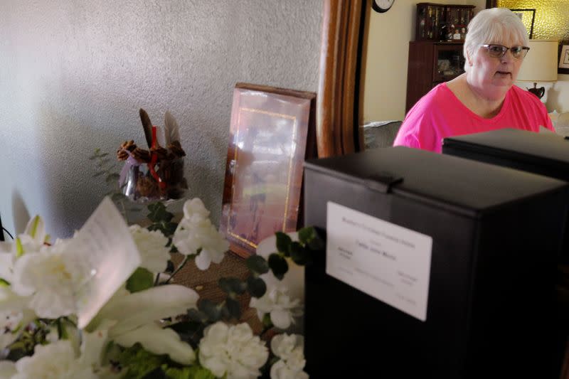 Debbie de los Angeles, whose mother died from coronavirus disease, poses for a portrait at her home in Monroe