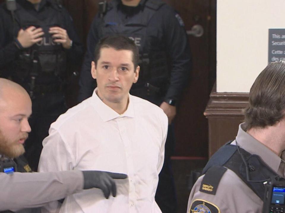 Kaz Henry Cox is led into court after being charged with murder in 2019. (CBC - image credit)