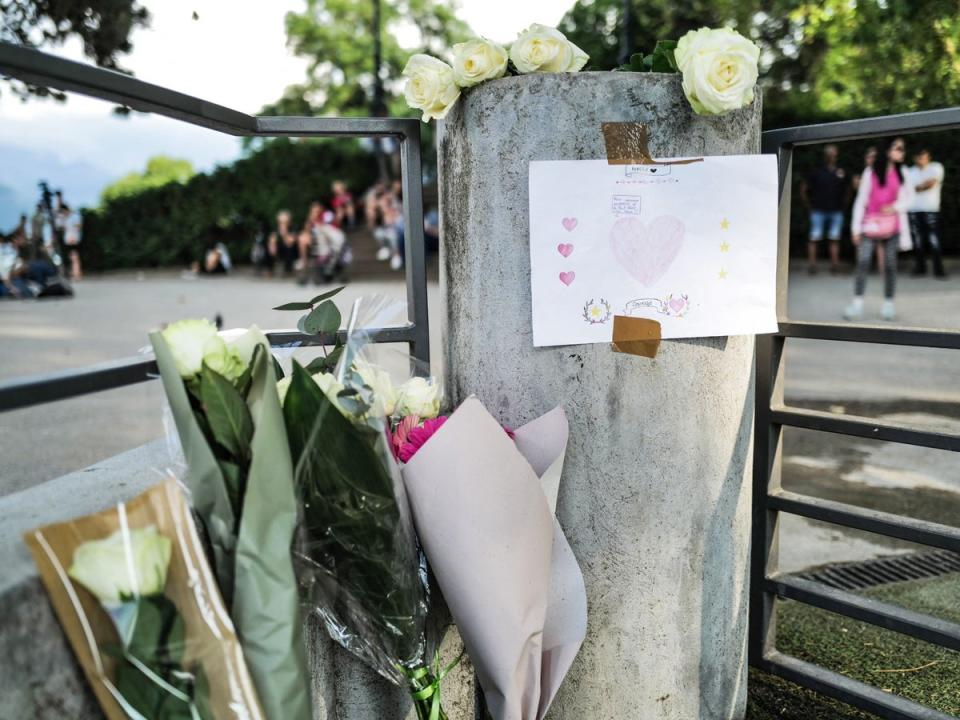Flowers and a message for the victims are placed at a playground in Annecy (Olivier Chassignole/AFP via Getty Images)