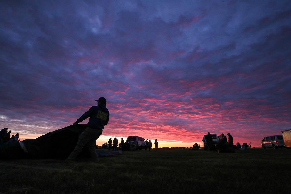 Crews prepare hot air balloons for the Kentucky Derby Festival Great Balloonfest Rush Hour Race at Bowman Field. Friday, April 26, 2024