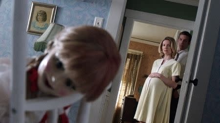 Annabelle Wallis as Mia and Ward Horton as John with the Annabelle doll in "Annabelle." REUTERS/Warner Bros.