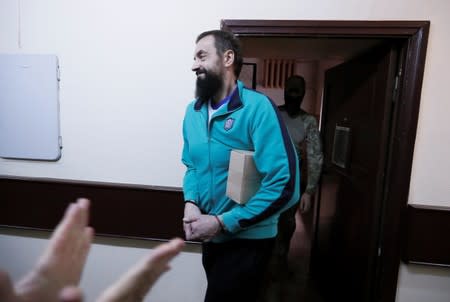 Crew member of Ukrainian naval ships, which were seized by Russia's FSB security service in November 2018, is escorted before a court hearing in Moscow