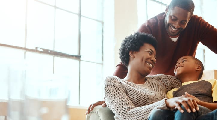 A mother and father who together qualify for the Child Tax Credit sit with their sit. 