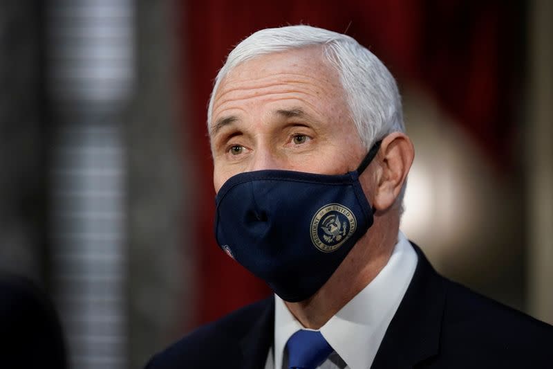 FILE PHOTO: Vice President Mike Pence finishes a swearing-in ceremony for Senators in the Old Senate Chamber at the Capitol in Washington