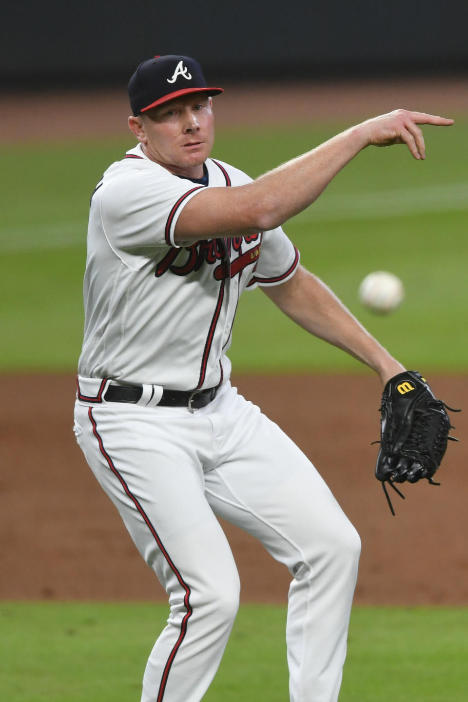 Atlanta Braves pitcher Mark Melancon turns a double play by throwing a ground ball by Miami Marlins' Matt Joyce to first base during the ninth inning of a baseball game Monday, Sept. 21, 2020, in Atlanta. Monte Harrison was tagged out at third base. (AP Photo/John Amis)