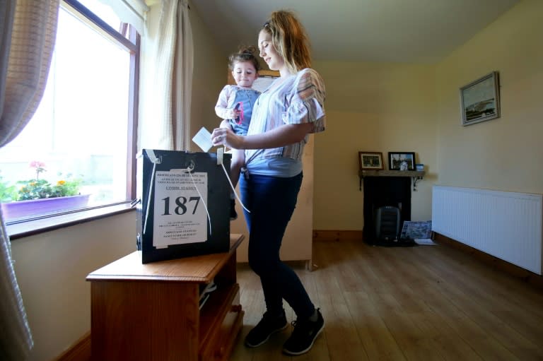 Local resident Colleen Ui Fhioruisce votes with her two-year-old daughter off the Donegal coast, where 29 people are registered to vote in the Irish abortion referendum on May 24, 2018