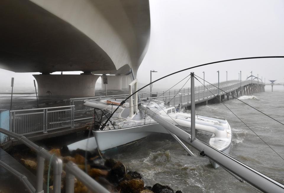 A trimaran sailboat was pushed by winds from Tropical Storm Nicole into the Tony Saprito Pier along the John Ringling Causeway in Sarasota, Florida on Thursday, Nov. 10, 2022. 