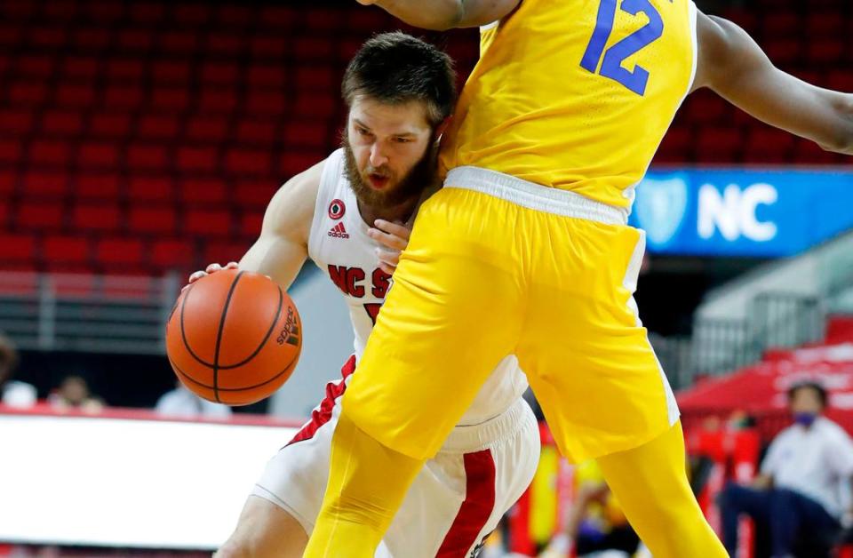 N.C. State’s Braxton Beverly (10) drives around Pittsburgh’s Abdoul Karim Coulibaly (12) during the second half of N.C. State’s 65-62 victory over Pittsburgh at PNC Arena in Raleigh, N.C., Sunday, February 28, 2021.