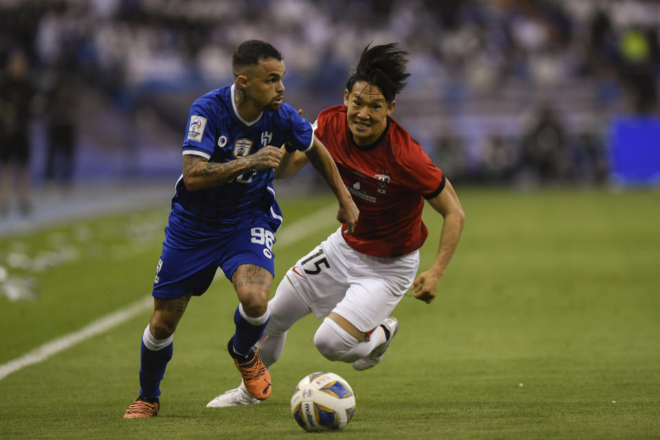 Japan's Urawa Red Diamonds' Takahiro Akimoto, right, fights for the ball with Saudi Arabia's Al Hilal' Michael Delgado, during their match in the first leg of the Asian Champions League final at King Fahd International Stadium, in Riyadh, Saudi Arabia, Saturday, April 29, 2023. (AP Photo)