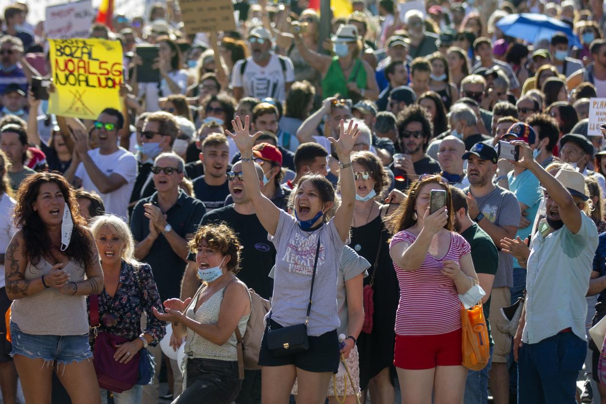 Thousands of demonstrators attend a protest against nationwide restrictions against COVID-19 in Madrid, Spain on Sunday, Aug. 16, 2020.