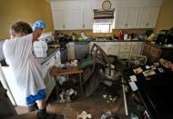 Samantha Labatut stands inside her flood damaged kitchen in St. Amant, Louisiana. REUTERS/Jonathan Bachman