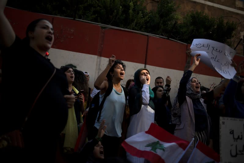 Demonstrators shout slogans during an anti-government protest outside the Central Bank of Lebanon in Beirut