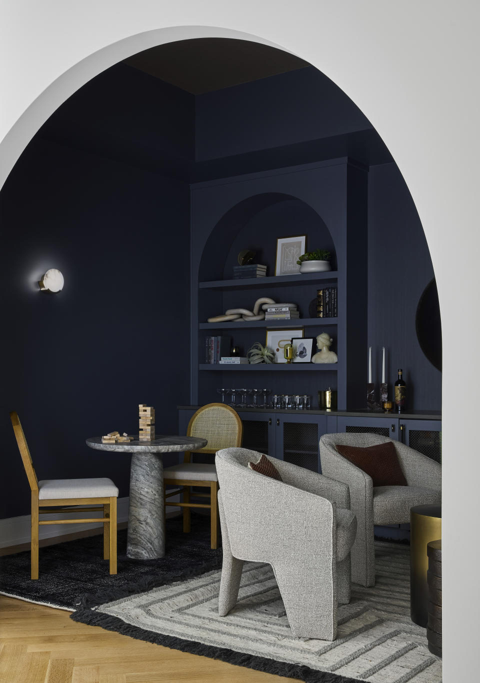This image provided by DGI Designs shows a modern boho home located in New Buffalo Michigan, DGI created a cool cozy alcove; the inky blue hue accentuates the curved ceiling and intimate space. (DGI Designs via AP)
