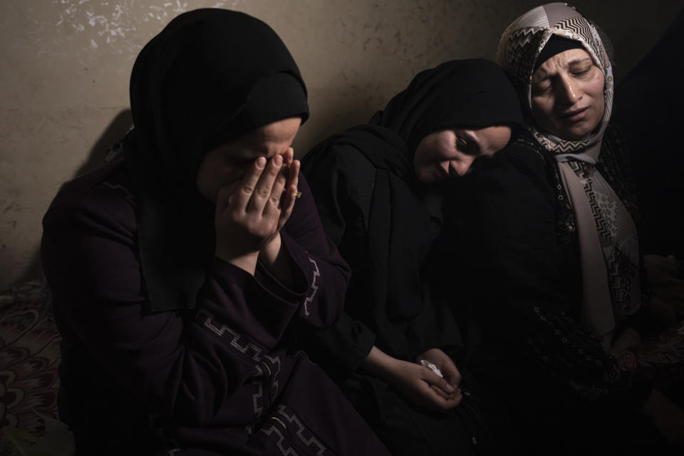 Relatives react during the funeral of Khalil Bahtini, the Islamic Jihad militant group's commander for the northern Gaza Strip, his wife and son, who were killed in an Israeli airstrike at their family home in Gaza City, Tuesday, May 9, 2023. Bahtini was among three senior Islamic Jihad commanders killed in targeted airstrikes early Tuesday. Palestinian health officials said at least 10 others were killed, including wives of two of the militants, several of their children and others nearby. (AP Photo/Fatima Shbair)