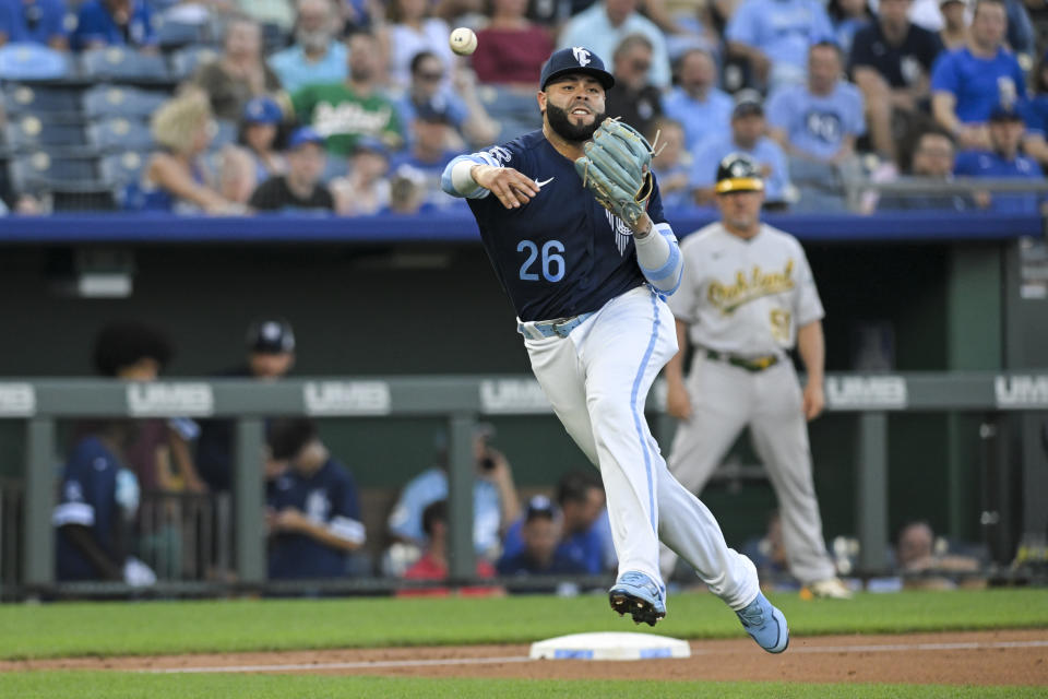 Kansas City Royals third baseman Emmanuel Rivera throws out Oakland Athletics' Elvis Andrus at first base during the third inning of a baseball game, Friday, June 24, 2022, in Kansas City, Mo. (AP Photo/Reed Hoffmann)