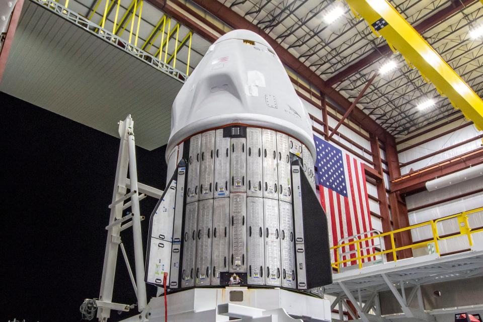 The Crew Dragon capsule is seen at Kennedy Space Center's pad 39A hangar this week ahead of attachment to its Falcon 9 rocket. The silver panels are used to protect the capsule's solar panels during transit.