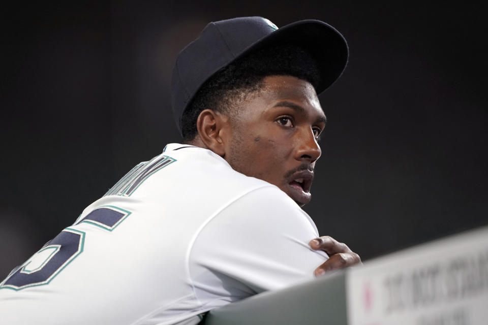 Seattle Mariners starting pitcher Justin Dunn leans on the dugout rail after he was pulled from a baseball game against the Chicago White Sox during the fifth inning, Wednesday, April 7, 2021, in Seattle. (AP Photo/Ted S. Warren)