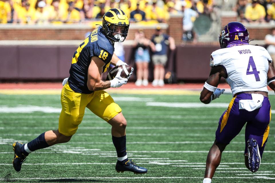 Michigan tight end Colston Loveland (18) makes a catch against East Carolina defensive back Julius Wood (4) during the first half at Michigan Stadium in Ann Arbor on Saturday, Sept. 2, 2023.