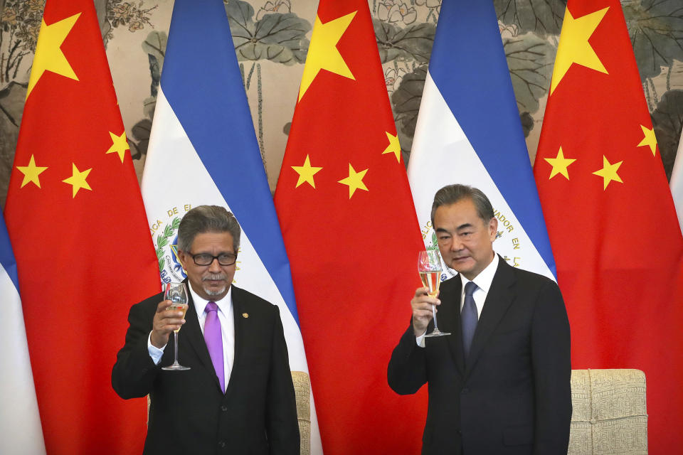 El Salvador's Foreign Minister Carlos Castaneda and China's Foreign Minister Wang Yi celebrate a toast at a signing ceremony to mark the establishment of diplomatic relations between El Salvador and China at the Diaoyutai State Guesthouse in Beijing, China, Tuesday, Aug. 21, 2018. (AP Photo/Mark Schiefelbein)